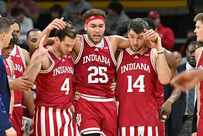 Indiana Hoosiers forward Race Thompson (25) walks off the court with forward Nathan Childress (14) and guard Michael Shipp (4) after an injury during the first half against the Iowa Hawkeyes at Carver-Hawkeye Arena.